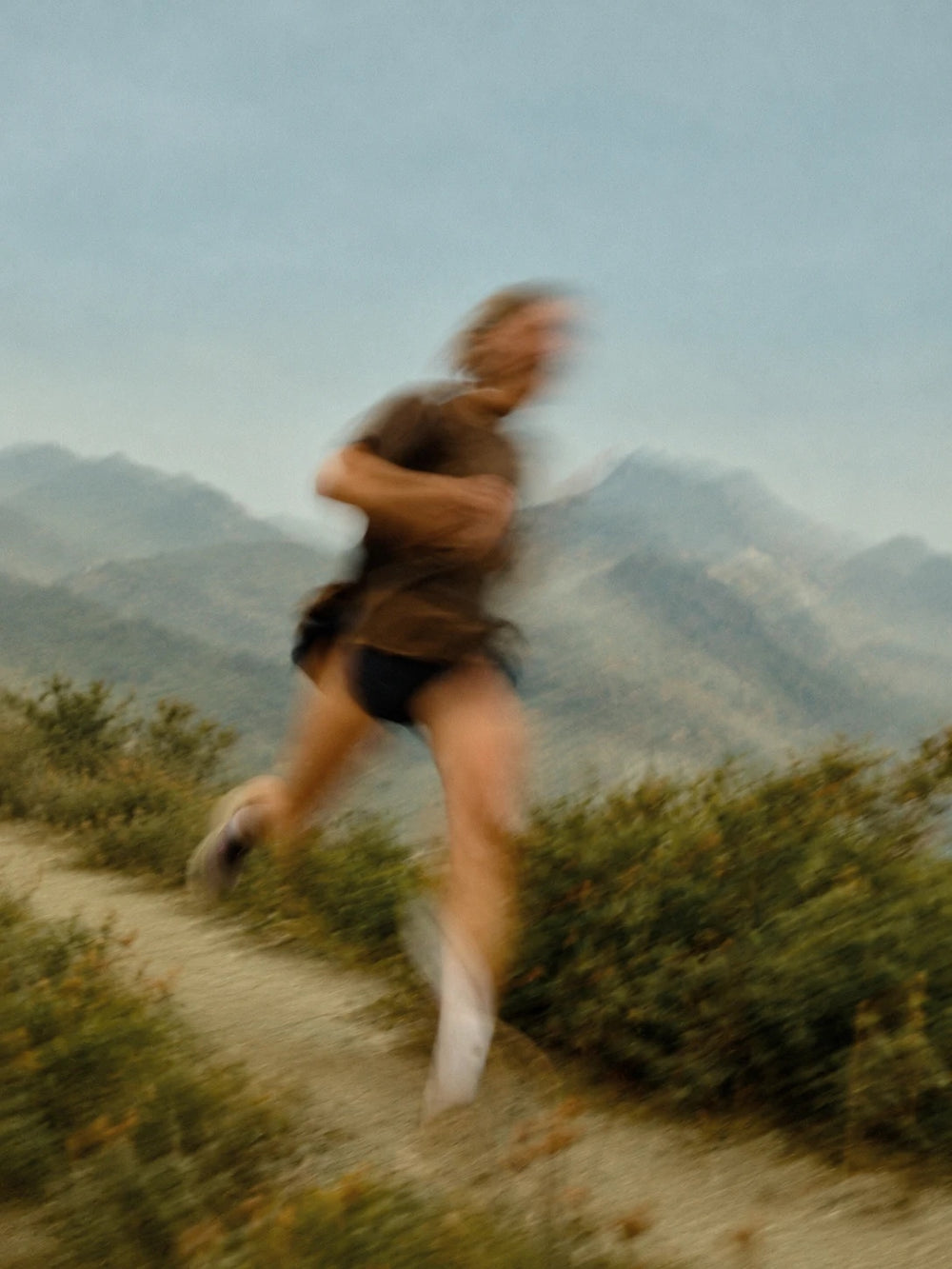 A runner on a mountain trail in motion blur